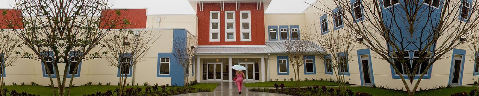 School building exterior with trees and lawn