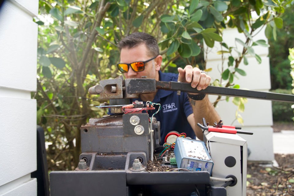 Technician working on gate mechanism equipment