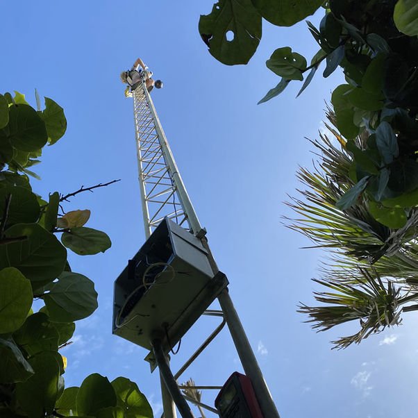 Communications tower and network equipment at an outdoor property location
